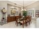 Formal dining area with a glass table, stylish chandelier, and plantation shutters at 15558 W Big Sky Dr, Surprise, AZ 85374