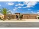 Well-maintained home featuring desert landscaping, a tile roof, and a three-car garage at 15558 W Big Sky Dr, Surprise, AZ 85374