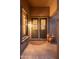 Close-up of a decorative glass front door with bronze textured facade and matching decor at 15558 W Big Sky Dr, Surprise, AZ 85374