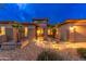 Exterior view of an inviting home with well-kept landscaping, rock features, and inviting entry at 15558 W Big Sky Dr, Surprise, AZ 85374