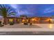 Inviting home exterior featuring a well-manicured yard, rock landscaping, and a three-car garage at 15558 W Big Sky Dr, Surprise, AZ 85374