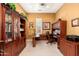 Home office featuring custom cabinetry, built-in desk and neutral carpeting at 15558 W Big Sky Dr, Surprise, AZ 85374