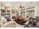 Bright living room featuring built-in shelves, a cozy fireplace, and neutral decor at 15558 W Big Sky Dr, Surprise, AZ 85374