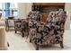 Comfortable seating in the living room with patterned armchairs, side tables, and a view of the stylish interior at 15558 W Big Sky Dr, Surprise, AZ 85374