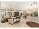 Open-concept living and dining area with tile flooring, neutral paint, and plantation shutters at 15558 W Big Sky Dr, Surprise, AZ 85374