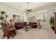 Spacious living room with vaulted ceilings, plantation shutters, and comfortable seating arrangement at 15558 W Big Sky Dr, Surprise, AZ 85374