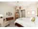 Inviting bedroom with a four-poster bed, neutral walls, and a seating area at 15558 W Big Sky Dr, Surprise, AZ 85374