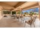 Expansive covered patio with seating, a BBQ area, and views of the outdoor landscape at 15558 W Big Sky Dr, Surprise, AZ 85374