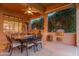 Covered patio with built-in grill and outdoor dining area, perfect for outdoor cooking and entertaining guests at 15558 W Big Sky Dr, Surprise, AZ 85374