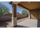 Covered back patio offering shade and views of the landscaped backyard at 16213 W Soft Wind Dr, Surprise, AZ 85387