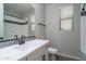 Bathroom featuring white vanity, sink, toilet, mirror, and shower at 16213 W Soft Wind Dr, Surprise, AZ 85387