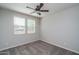 Bedroom with neutral walls, carpet, two large windows and ceiling fan at 16213 W Soft Wind Dr, Surprise, AZ 85387