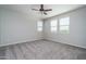 Bedroom with a ceiling fan, plush carpeting, and windows, ready for relaxation and rest at 16213 W Soft Wind Dr, Surprise, AZ 85387