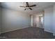 Bedroom with a ceiling fan and neutral carpeting, offering a blank canvas for personalization at 16213 W Soft Wind Dr, Surprise, AZ 85387