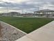 Well-maintained common area with a grassy field and picnic shelters at 16213 W Soft Wind Dr, Surprise, AZ 85387
