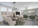 Open dining and living area with modern decor, stylish furniture and wood-look floors at 16213 W Soft Wind Dr, Surprise, AZ 85387