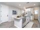 Spacious kitchen with white cabinets, stainless steel appliances and an island with seating at 16213 W Soft Wind Dr, Surprise, AZ 85387