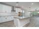 Modern kitchen featuring white cabinets, stainless steel appliances, and a large center island at 16213 W Soft Wind Dr, Surprise, AZ 85387