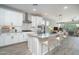 Modern kitchen with white cabinets, granite countertops, stainless appliances and an island with seating at 16213 W Soft Wind Dr, Surprise, AZ 85387