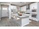 Bright kitchen featuring white cabinets, stainless steel appliances, and a large center island with seating at 16213 W Soft Wind Dr, Surprise, AZ 85387
