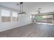 Open living area with tile floors, a ceiling fan and sliding doors leading to the patio at 16213 W Soft Wind Dr, Surprise, AZ 85387