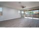 Bright living room with tile flooring, large sliding glass doors to the patio and a ceiling fan at 16213 W Soft Wind Dr, Surprise, AZ 85387