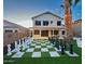 Backyard of a home with a giant chessboard, black and white chess pieces, and string lights at 17311 N Kimberly Way, Surprise, AZ 85374