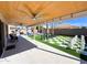 Spacious covered patio with ceiling fan, a grill, outdoor furniture, an inground hot tub, and a giant chess set at 17311 N Kimberly Way, Surprise, AZ 85374