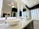 The spacious bathroom features double vessel sinks and a modern, minimalist aesthetic at 17311 N Kimberly Way, Surprise, AZ 85374