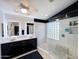 Modern bathroom featuring a double sink vanity and walk-in shower with glass block window at 17311 N Kimberly Way, Surprise, AZ 85374