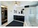 Modern main bathroom showcasing black and white tiles, a walk-in closet, and a glass enclosed shower at 17311 N Kimberly Way, Surprise, AZ 85374