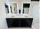 Bathroom with double vanity, backlit mirrors, and modern sinks at 17311 N Kimberly Way, Surprise, AZ 85374