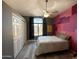 Cozy bedroom with large window, closet, and painted accent wall at 17311 N Kimberly Way, Surprise, AZ 85374