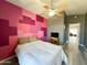 Bright bedroom with a large window offering natural light and patterned accent wall at 17311 N Kimberly Way, Surprise, AZ 85374