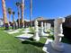 Backyard of a home with a giant chessboard, black and white chess pieces and tall palm trees at 17311 N Kimberly Way, Surprise, AZ 85374