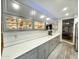 The kitchen features custom cabinets with glass displays, ample counter space, and stainless steel appliances at 17311 N Kimberly Way, Surprise, AZ 85374