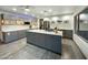Spacious kitchen with gray cabinets, center island, stainless steel appliances, and quartz countertops at 17311 N Kimberly Way, Surprise, AZ 85374