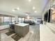 Modern kitchen with gray cabinets, stainless steel appliances, quartz counters, and an open layout to the living room at 17311 N Kimberly Way, Surprise, AZ 85374