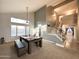 Bright living room features vaulted ceiling, large windows, pool table, and stairway access to the second floor at 17311 N Kimberly Way, Surprise, AZ 85374