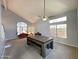 Bright living room with a fan, vaulted ceilings, and large windows providing natural light at 17311 N Kimberly Way, Surprise, AZ 85374