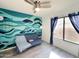 Bright living room featuring an accent wall, ceiling fan, and natural light from a window at 17311 N Kimberly Way, Surprise, AZ 85374