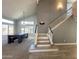Open-concept living area featuring stairs, abundant natural light, and neutral-toned walls and flooring at 17311 N Kimberly Way, Surprise, AZ 85374
