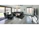 Cozy living room with wood-look floors, neutral colors, and large windows at 17311 N Kimberly Way, Surprise, AZ 85374