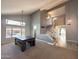 Spacious living area with high ceilings, staircase, neutral decor, and large windows overlooking the backyard at 17311 N Kimberly Way, Surprise, AZ 85374