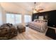 Spacious main bedroom featuring a ceiling fan, two windows, and a seating area at 17311 N Kimberly Way, Surprise, AZ 85374
