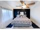 Bright, airy main bedroom with ceiling fan, two windows, and calming decor at 17311 N Kimberly Way, Surprise, AZ 85374