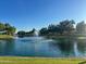 Picturesque pond featuring a central fountain, lush landscaping, and mature trees, offering a tranquil setting at 17311 N Kimberly Way, Surprise, AZ 85374