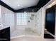 Bright walk-in shower area featuring white tiles, a glass block window, and a rain-style shower head at 17311 N Kimberly Way, Surprise, AZ 85374