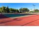 Outdoor tennis court with mature trees, providing a lovely area for friendly competition at 17311 N Kimberly Way, Surprise, AZ 85374