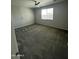 Bright bedroom with a large window and neutral carpet, offering a blank canvas at 18231 W Paraiso Dr, Surprise, AZ 85387